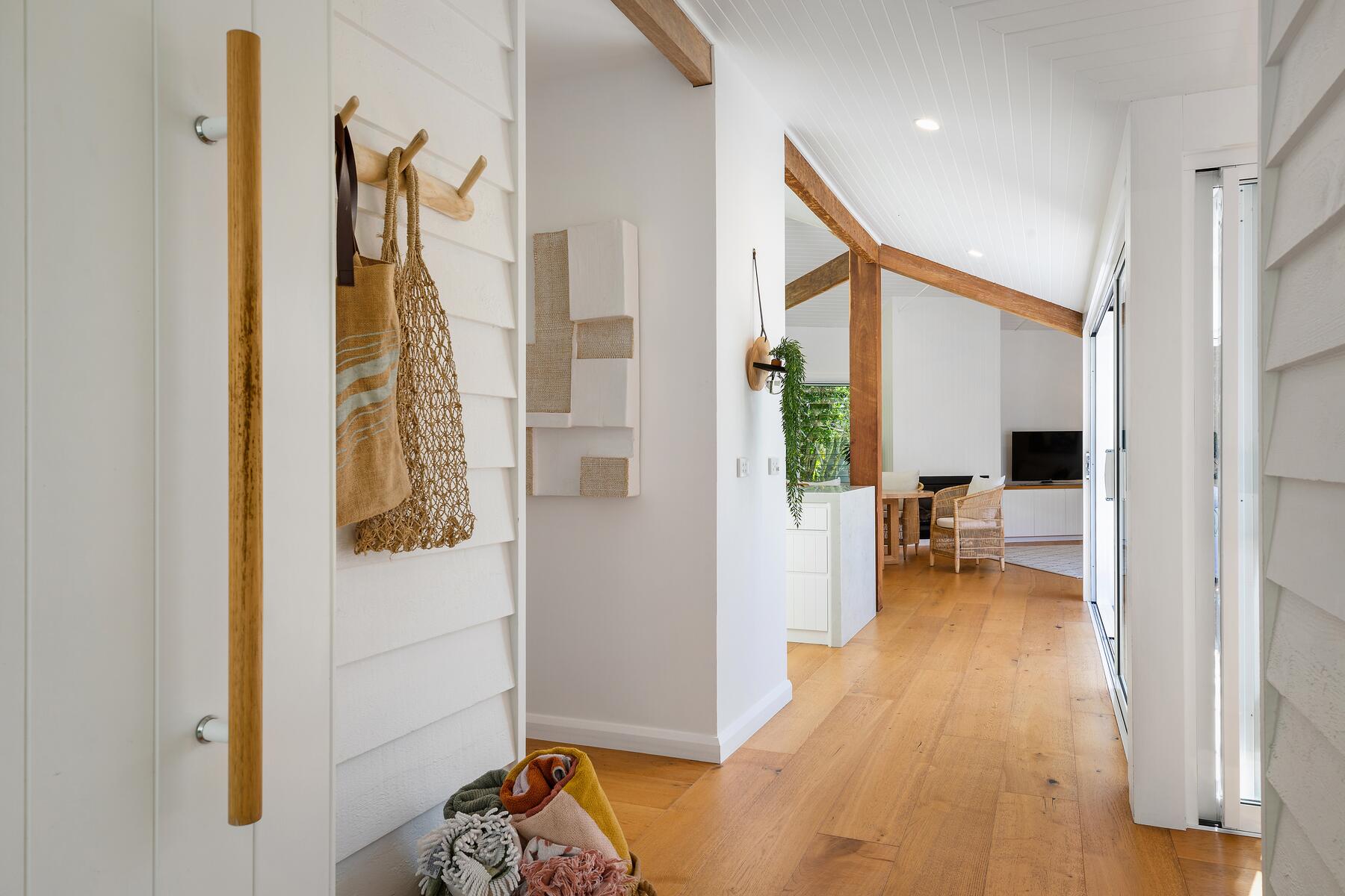 Modern architect designed alterations and additions entrance hallway with white walls and timber floors