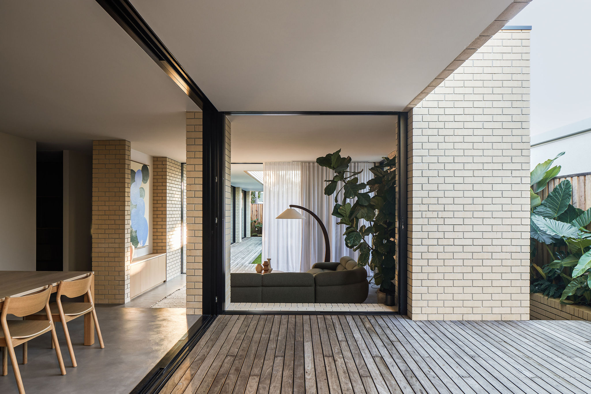Modern Architect-designed house large sliding doors timber deck courtyard looking towards living room