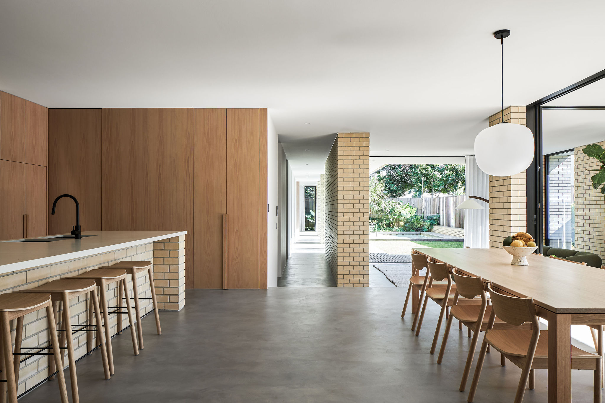 Modern architect designed home with microcement floors, cream face brick walls, oak veneer joinery