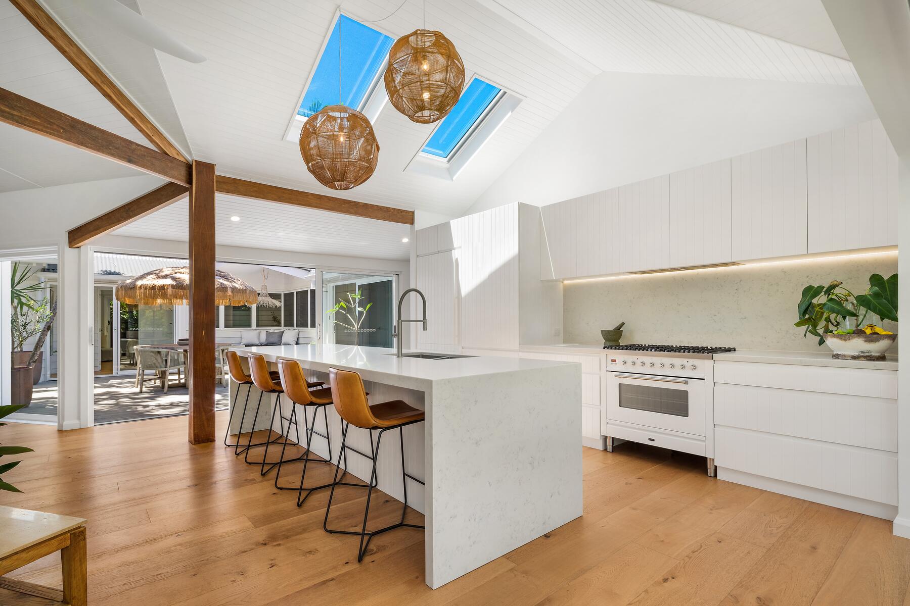 Modern architect designed kitchen white stone benchtops, VJ board cabinets