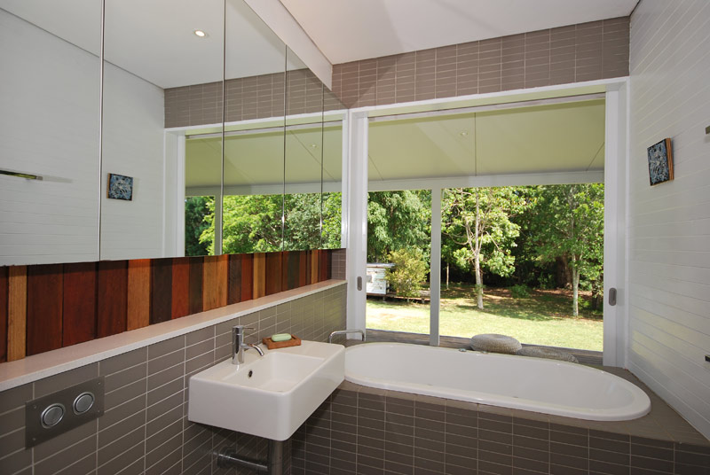 Architect designed bathroom renovations, built-in bath with large sliding doors to back verandah