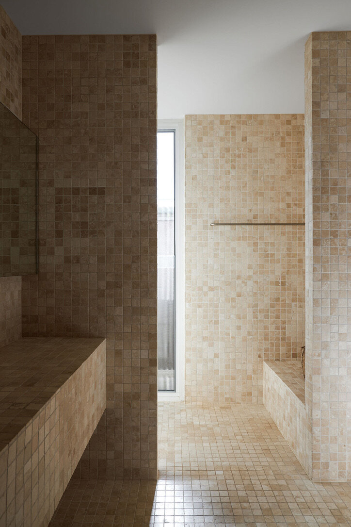Modern architect designed bathroom, cream square tiles to walls, floor and basin