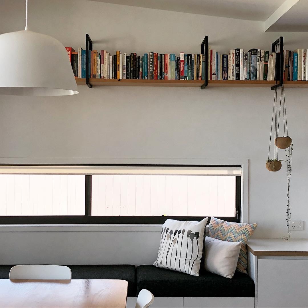Architect designed renovations horizontal slot window, daybed and bespoke shelving above
