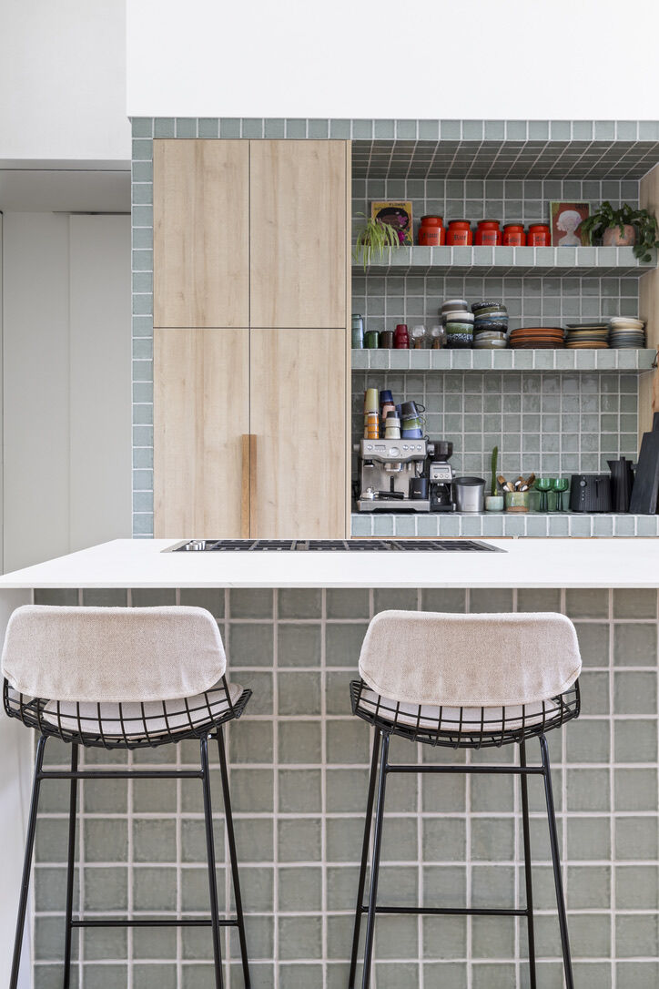 Modern architect designed kitchen with tiled surround, timber laminate cabinets and porcelain benchtops