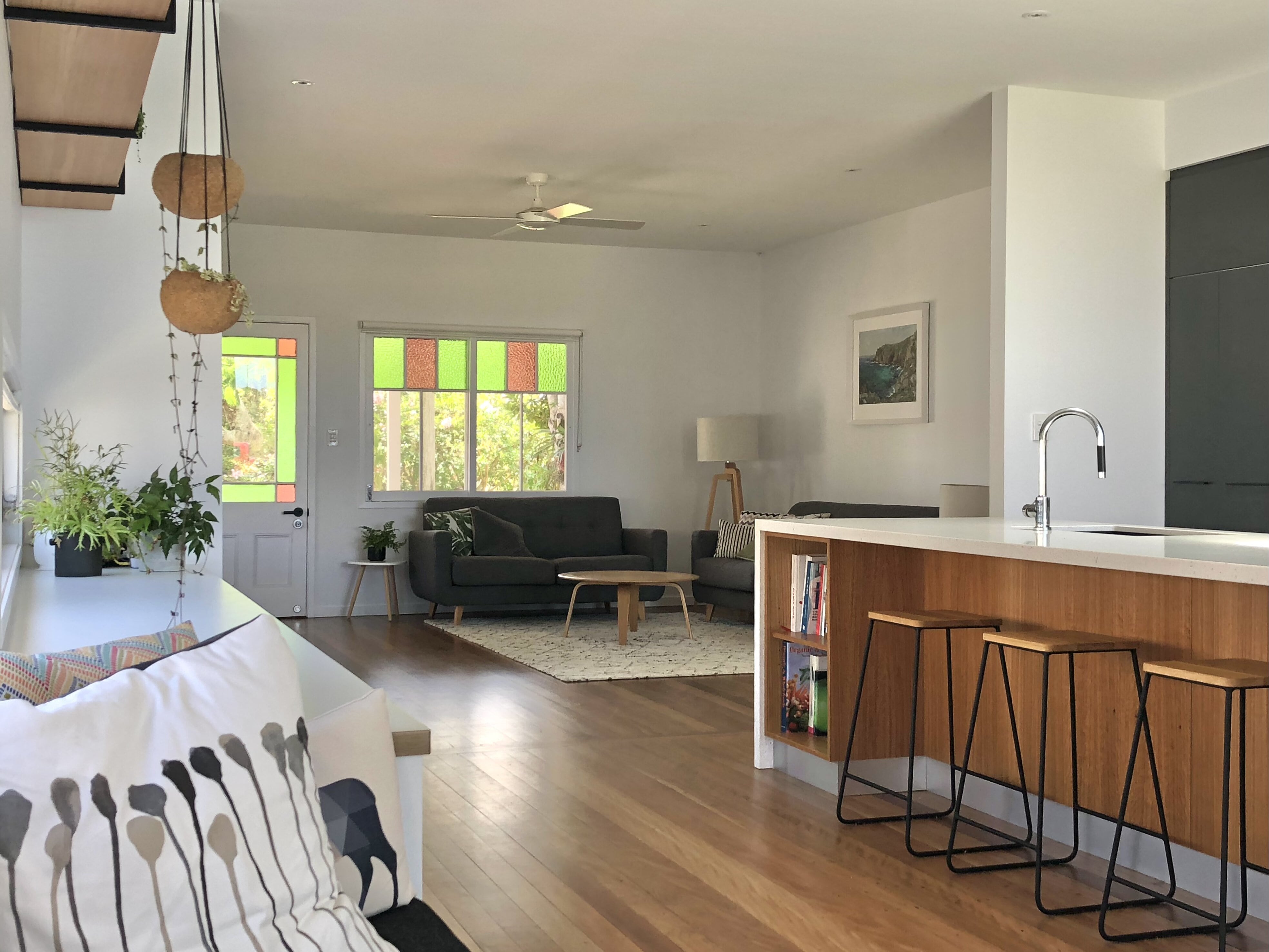 Architect designed alterations and additions timber floors white walls and daybed