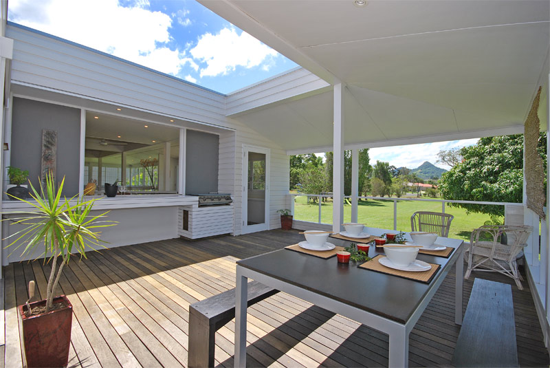 Architect designed renovations to queenslander home timber verandah with BBQ and views to Mt Chincogan
