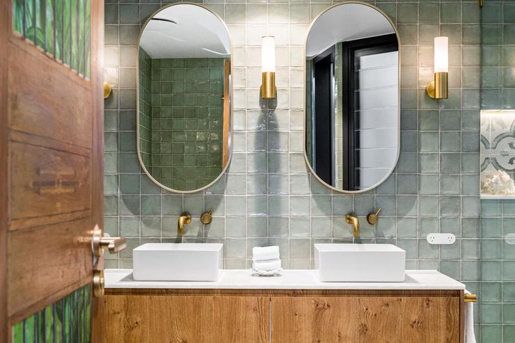 Modern architect designed bathroom with timber vanity, stone benchtop, mirrors and topmount basins