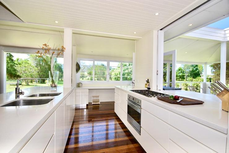 Modern architect designed kitchen white cabinets, white Caesarstone benchtops