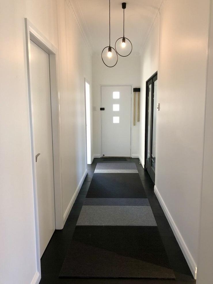 tretford custom hallway runner white walls black circular light fittings